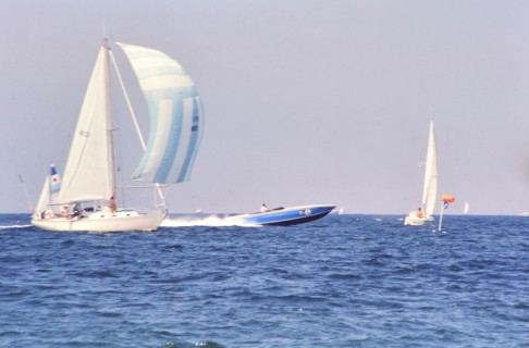 Sailboats and speedboat off the coast of Florida