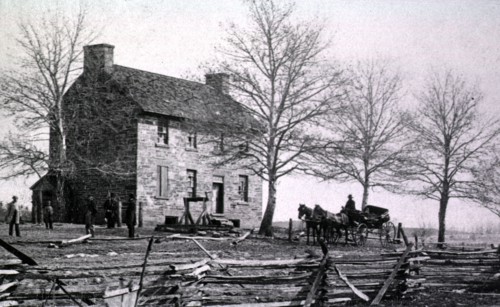 Several men stand outside of Mathew's house