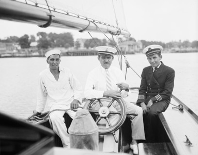 Three men on a deck of a sailboat