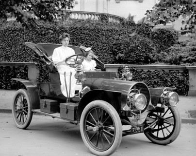 Woman driving an automobile in early 1900s