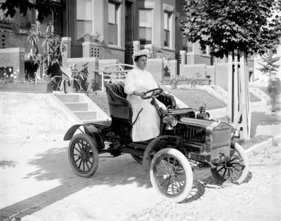 Woman driving an automobile in early 1900s