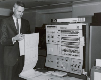 Worker reading printout sheet July 1967 in front of IBM 360