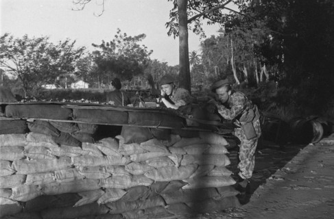 Dutch Soldiers in position behind a reinforcement with sandbags in Indonesia, Dutch East Indies ca. 1947