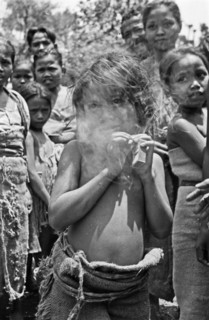 A young girl smokes a cigarette in Indonesia, Java, Dutch East Indies, Salatiga ca. 1947
