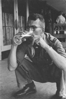 Man drinks a glass of beer and holds a beer bottle in his other hand; Date June 1947; Location Batavia, Indonesia, Jakarta, Dutch East Indies