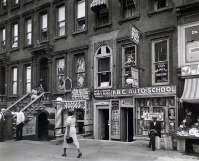 Woman walking in Harlem New York 422-424 Lenox Avenue, Manhattan ca. 1938