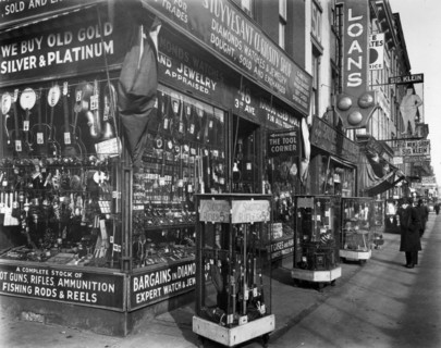 Stuyvesant Curiosity shop, with guns, binoculars, in cases in front; instruments, knives, other goods in window; loan and 'fat men's' shop. Pawn Shop, 48 Third Avenue, Manhattan. ca. 1937