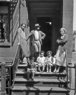 Three generations of African Americans on stoop of brick home with iron rails on steps. Jay Street, No. 115, Brooklyn ca. 1936
