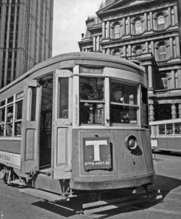 1930s New York City - Third Ave. trolley in front of old Post Office, and Woolworth building, left, driver and riders visible through windows ca. 1938