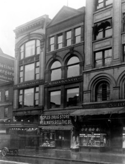 Exterior of People's Drug Store, 11th and G Streets, Washington, D.C., with other shops ca. 1909-1932