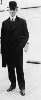 Henry Ford, full-length portrait, standing, facing left 1916