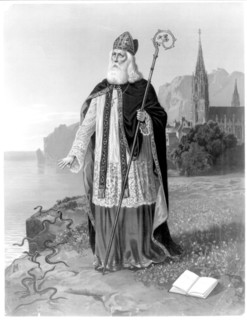 St. Patrick pray for your children, printed on open book with saint in foreground, church in background ca. 1888