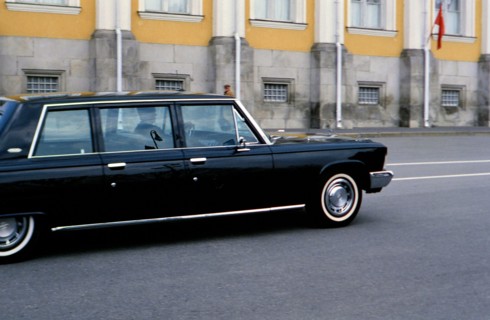 Luxury automobile driving down street in Russian city ca. 1970s (1978)
