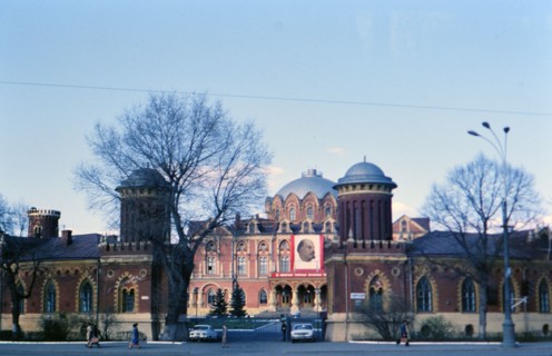 Soviet Buildings and Architecture - a building adorned with a large banner of Vladimir Lenin in a large city in Russia in the late 1970s (1978)