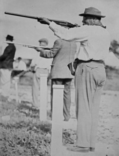 Composer and conductor John Philip Sousa, shooting a gun ca. 1910-1915