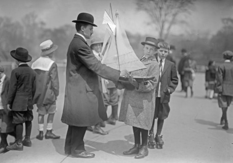 A man and boys with a model yacht at Conservatory Lake, Central Park, New York City ca. 1910-1915