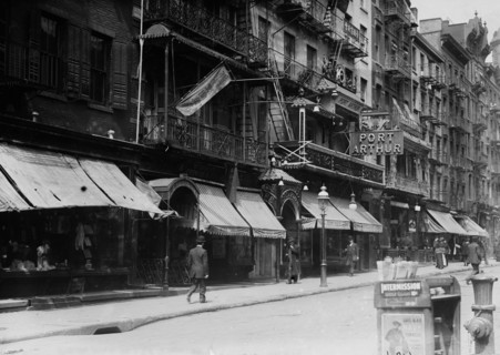 Mott Street in Chinatown, New York City. Church of the Transfiguration in the background and the Port Arthur restaurant at 7-9 Mott Street ca. 1910-1915