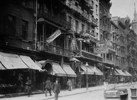 Mott Street in Chinatown, New York City. Church of the Transfiguration in the background and the Port Arthur restaurant at 7-9 Mott Street ca. 1910-1915