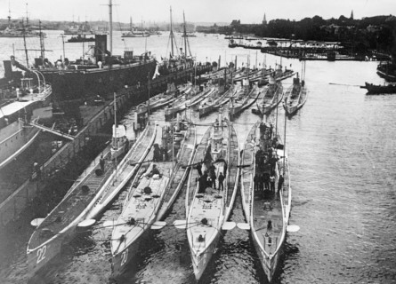 German submarines in a harbor. Front row (left to right): U-22, U-20 (sank the Lusitania), U-19 and U-21. Back row (left to right): U-14, U-10 and U-12 ca. 1914-1915