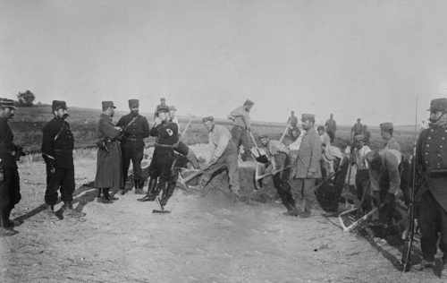 German prisoners burying dead soldiers, near Reims, France during World War I ca. October 1914