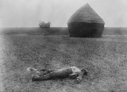 Dead German lying near a haystack, during World War I in France ca. 1914