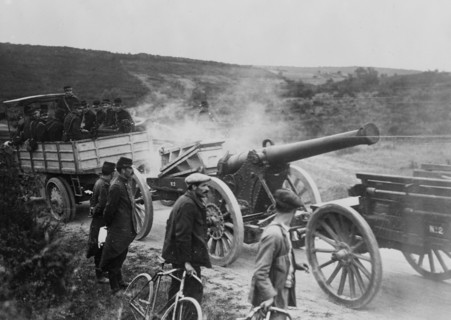 French soldiers in motor tractor which is pulling a large gun along the road at the beginning of World War I ca. 1914-1915