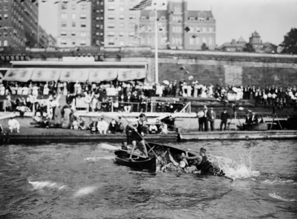 Men enjoying the summer fun of canoe tilting ca. 1910-1915