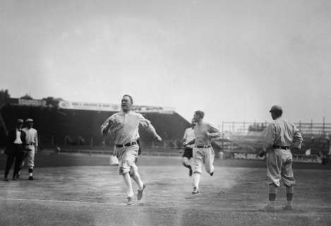 Hick Cady of Boston Red Sox wins foot race with Jack O'Brien (Boston Red Sox trainer, pin shorts, partially obscured) and teammate Buck O'Brien (looking to his right) at Fenway Park, Boston (baseball)...