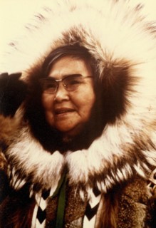 Early 1970s - Eskimo woman with tour group organization in Kotzebue greeting visitors at airport