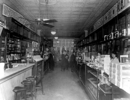 Interior of People's Drug Store, 11th and G Streets, Washington, D.C., with employees behind the counters and customers ca. 1909-1932