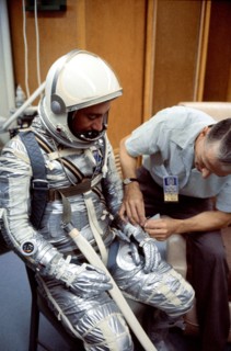 (1961) A NASA suit technician adjusts astronaut Virgil I. (Gus) Grissom's Mercury pressure suit during prelaunch activities at the Florida Space Center.