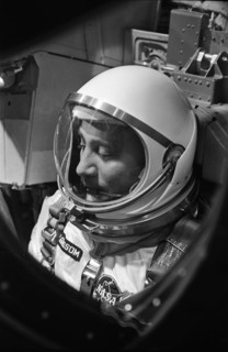 (23 March 1965) Astronaut Virgil I. Grissom, the command pilot of the Gemini-Titan 3 mission, is shown through the window of the open hatch on the Gemini spacecraft in the white room on the morning of...