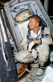 (25 Oct. 1965) Astronaut Frank Borman, command pilot for the Gemini-7 spaceflight, looks over the Gemini-7 spacecraft during weight and balance tests.