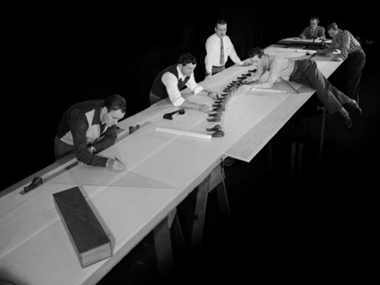 Draftsmen in the Materials and Stresses Building at the National Advisory Committee for Aeronautics (NACA) Lewis Flight Propulsion Laboratory create a template for a compressor using actual compressor...