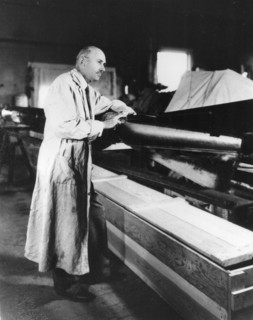 Robert Goddard with a rocket in his workshop at Roswell, NM. October 1935.