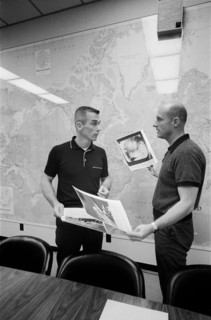 (2 June 1966) Astronauts Thomas P. Stafford (right) and Eugene A. Cernan look over pictures of the lunar surface taken by Surveyor I.