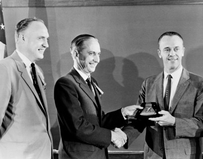 (1 Oct. 1961) Astronaut Alan B. Shepard Jr. (right) receives a plaque and award from members of the British Rocket Society.