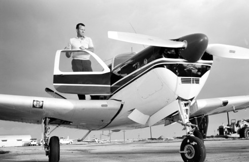 (1963) Astronaut L. Gordon Cooper Jr., prime pilot for the Mercury Atlas 9 (MA-9) 22-orbit flight, stands by his privately owned Beechcraft Bonanza aircraft, at Patrick Air Base, Florida.