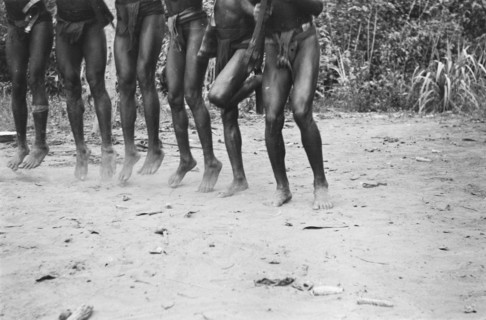 Papuans armed with guns do a war dance; Date November 10, 1947; Location Indonesia, Dutch East Indies
