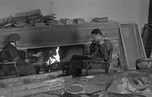 Warsaw Uprising: Wieslaw Chrzanowski "Wieslaw" (with MP40 submachine gun) and Jerzy Sikorski "Sixton" (on the left) from "Anna" company of batallion "Gustaw" in house on Jasna 19 Street after surrende...