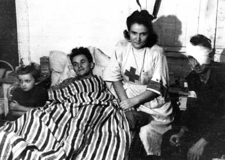 Warsaw Uprising: Nurse Janina Steczniewska "Inka" with daughter Hania and wounded insurgent Edmund Michniewski "Mis" in the hospital of "Koszta" Company ca. August 1944