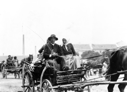 Man and woman on horse-drawn wagon, returning from market, Hungary 1923