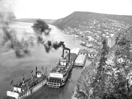 Riverboats distant view of town 1900-1923 possibly Ruby, Alaska yukon river