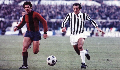 Franco Nanni from Bologna (left) and Giuseppe Furino from Juventus (right) chase the ball during a match between Bologna and Juventus ca. 1975-1978