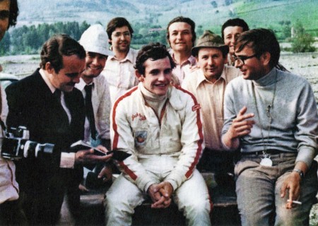 Belgian car driver Jacky Ickx (in the center), and the Italian engineer and builder Gian Paolo Dallara (on the right), in a conversation on the Varano de 'Melegari circuit ca. late 1960s or early 1970...