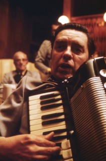 Closeup of an Accordionist Who Accompanies the Concord Singers as They Practice Singing German Songs in New Ulm Minnesota... ca. 1975