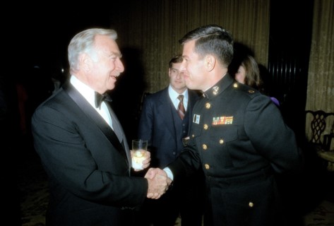 A Marine Corps major shakes hands with Walter Cronkite