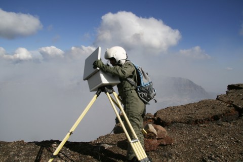 Geologist changing the data card from the time-lapse camera on the north rim of Pu'u 'Ö'ö cone - Kilauea, HI ca. July 2010