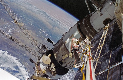 Cosmonaut Vasili V. Tsibliyev, Mir-23 commander, operates at the end of the Russian Mir Space Stations STRELA boom during a space walk on April 29, 1997