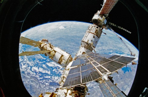 View of Mir Space Station as seen from flight deck overhead window and Spacehab